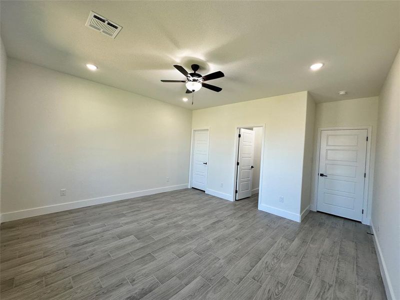 Unfurnished bedroom featuring ceiling fan and wood-type flooring