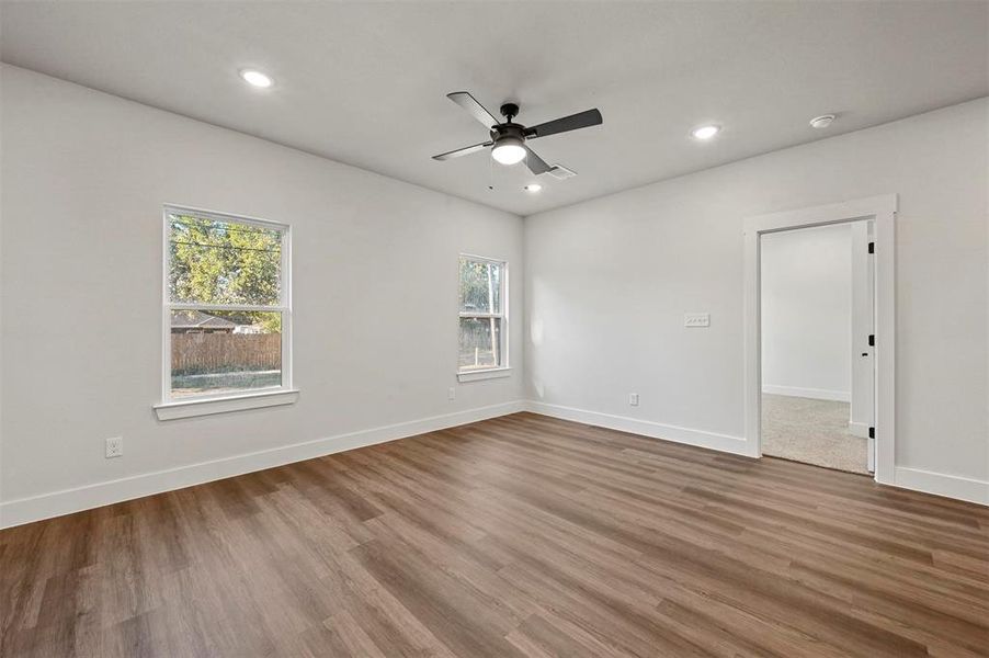 Spare room with wood-type flooring and ceiling fan