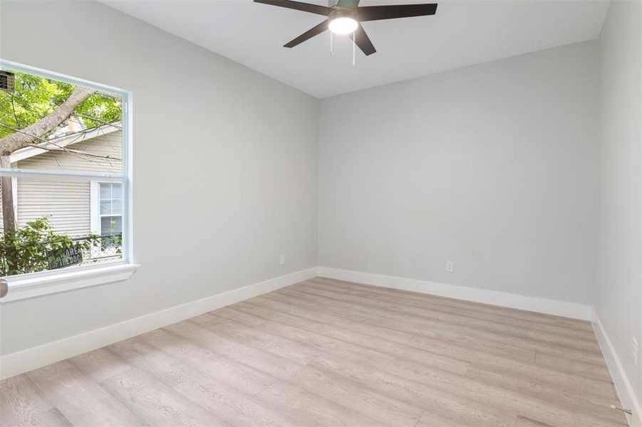 Empty room featuring ceiling fan and light hardwood / wood-style floors