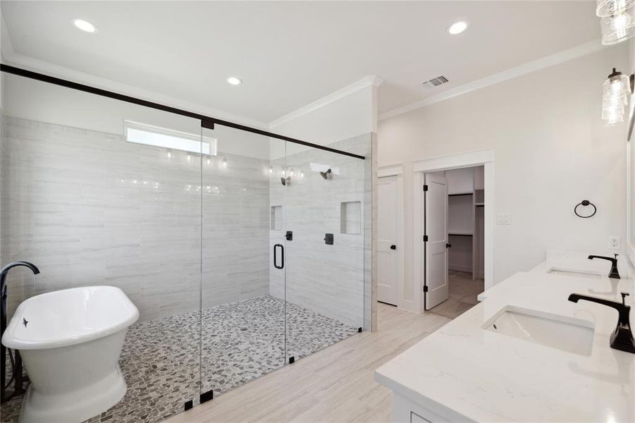 Bathroom featuring ornamental molding, an enclosed shower, and dual bowl vanity