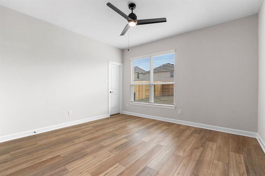 Large, primary bedroom with beautiful windows.