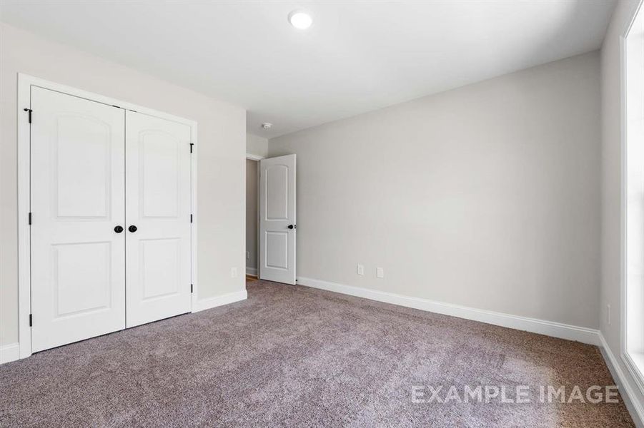 Unfurnished bedroom with a closet and carpet flooring