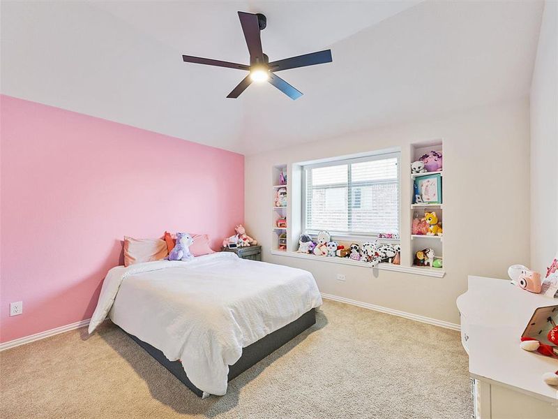 Carpeted bedroom featuring ceiling fan