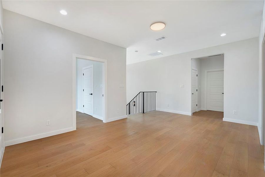 Empty room with light hardwood / wood-style flooring