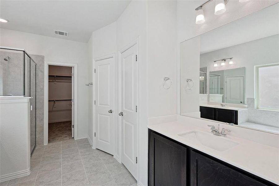 Bathroom featuring double vanity and tile patterned flooring