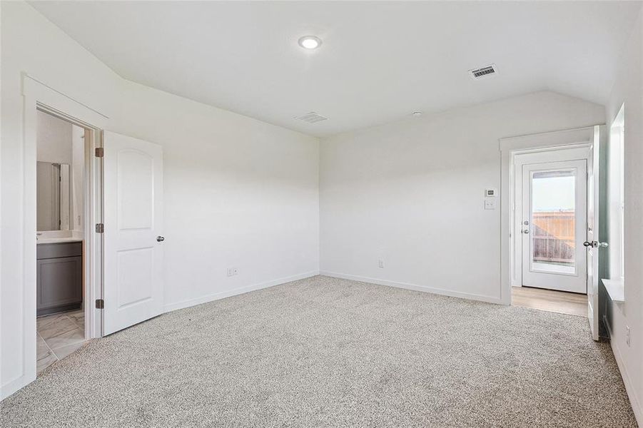 Carpeted spare room with lofted ceiling