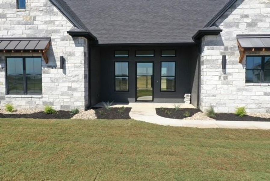 Property entrance featuring french doors and a yard