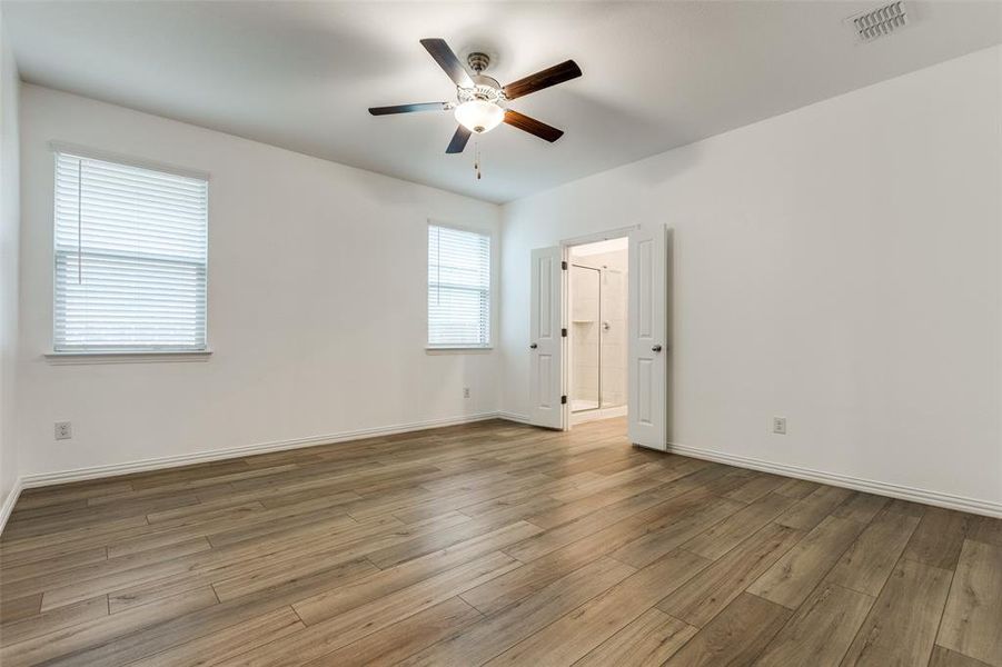 Unfurnished room featuring ceiling fan and light hardwood / wood-style flooring