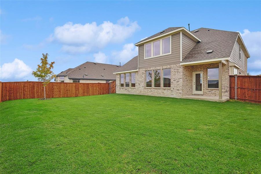 Back of house featuring a yard and a patio