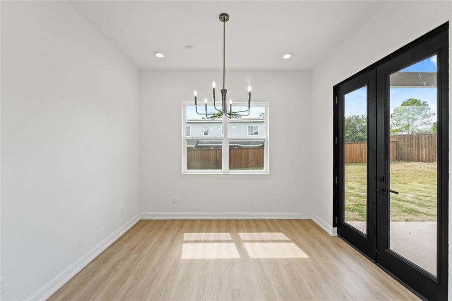 Unfurnished dining area with a healthy amount of sunlight and light hardwood / wood-style flooring