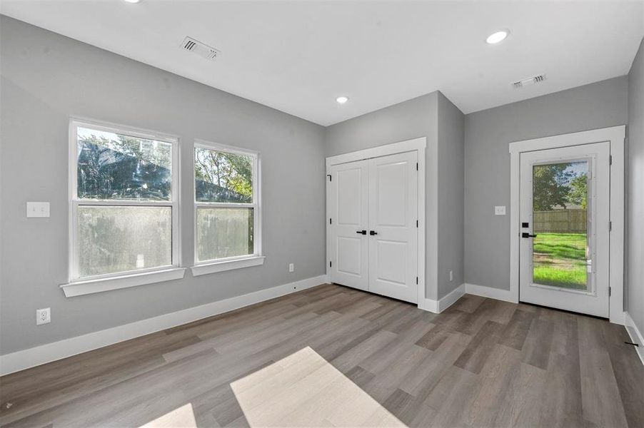 Unfurnished bedroom with light hardwood / wood-style flooring and a closet