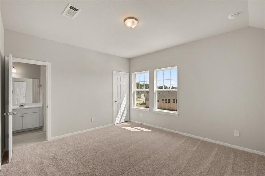 Your secondary bedroom features plush carpet, fresh paint, closet, and a large window that lets in plenty of natural lighting.