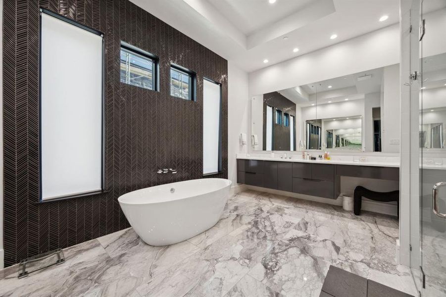 Bathroom featuring a bathtub, tile patterned floors, vanity, and a raised ceiling