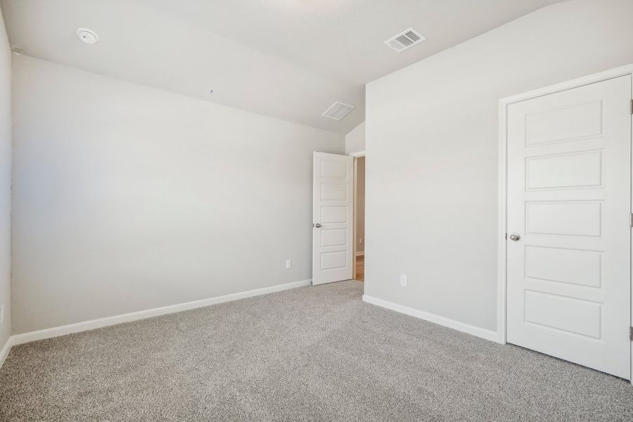 Guest bedroom in the Fitzhugh floorplan at a Meritage homes community.