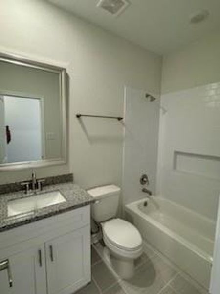 Secondary bath tub/shower combo with tile surround