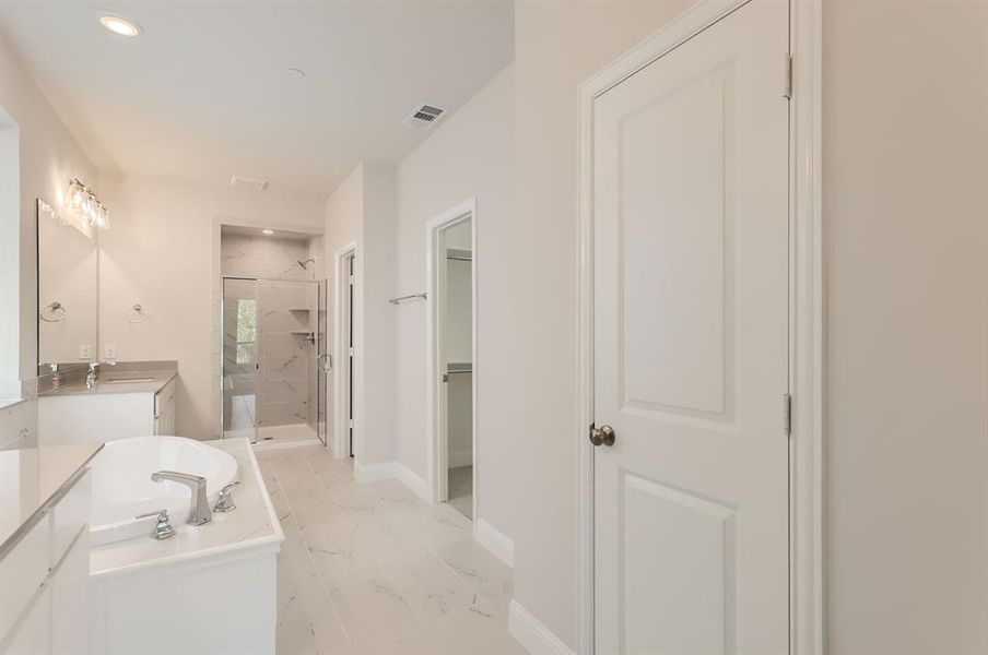 Bathroom with vanity, shower with separate bathtub, and tile patterned flooring