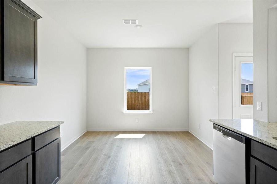 Dining area with a wealth of natural light and light wood-style floors