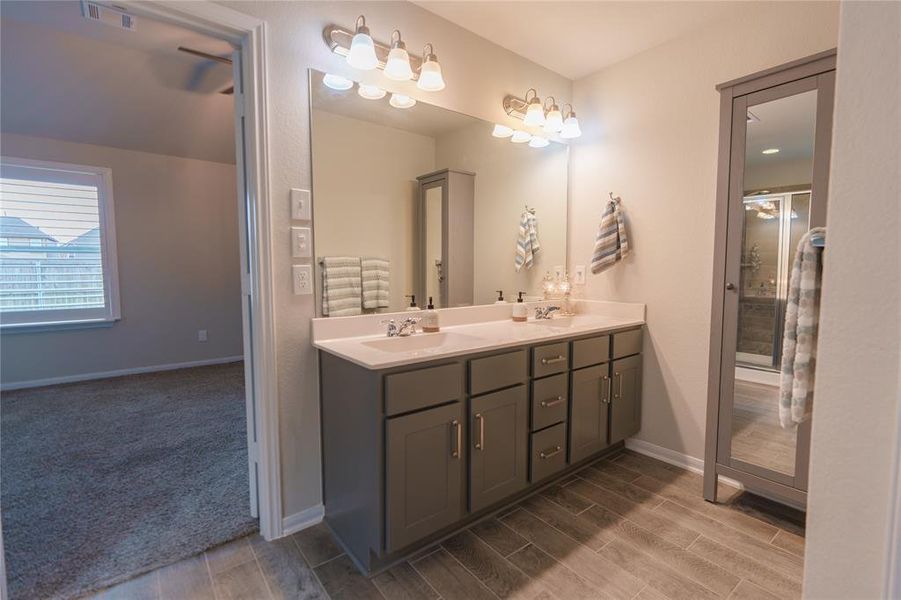 Primary bathroom. Double sinks. Linen storage with mirror.