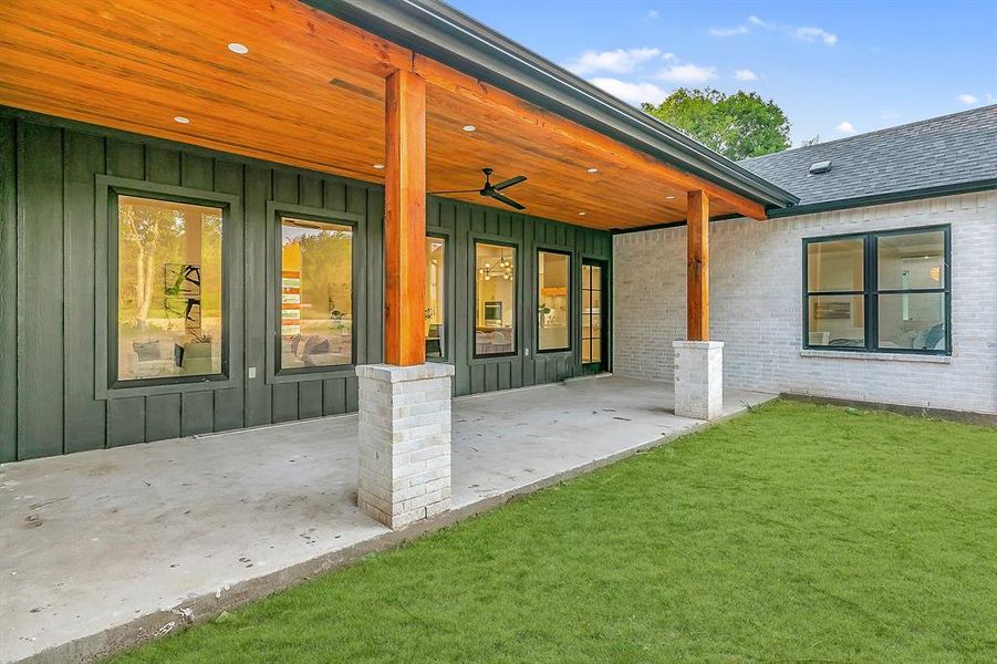 View of terrace featuring ceiling fan and stunning cedar wood beams and shiplap ceilings.