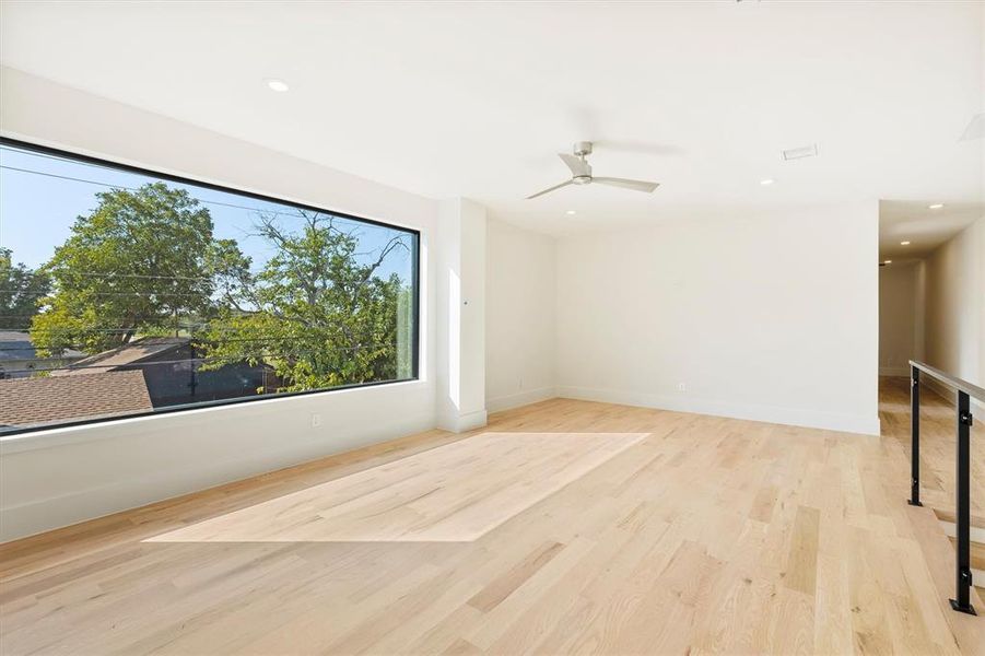 Spare room featuring light wood-type flooring and ceiling fan