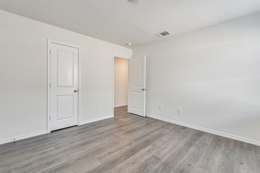 Unfurnished bedroom featuring hardwood / wood-style flooring