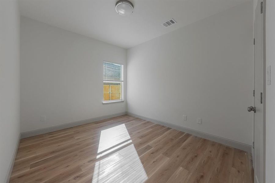 Empty room with light hardwood / wood-style floors