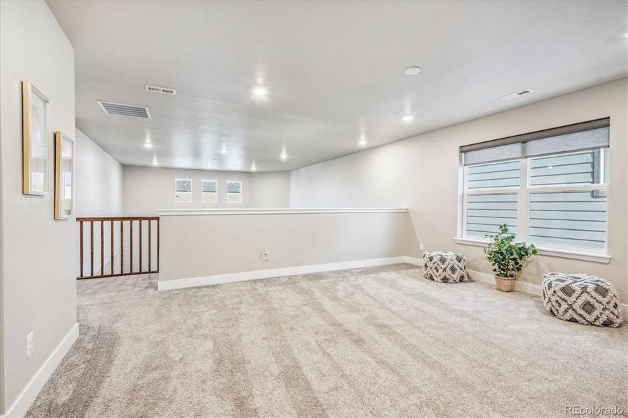 Loft looks over great room to add dimension and light