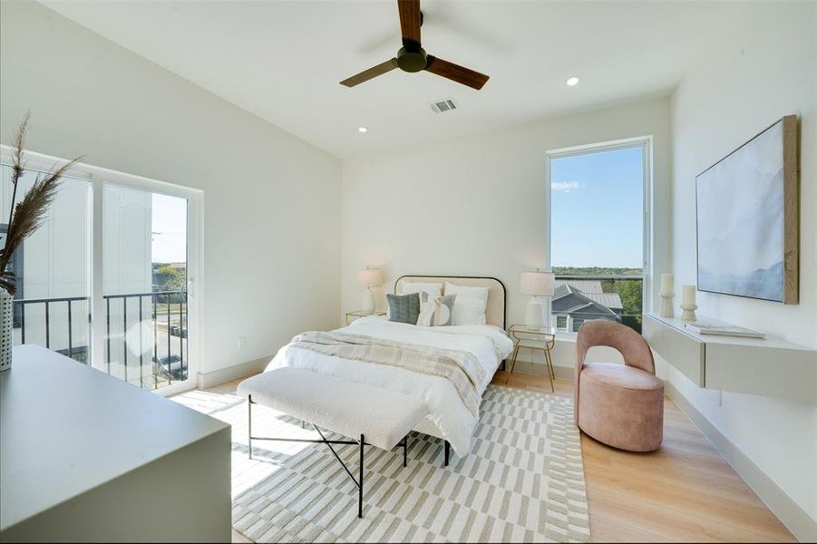 Bedroom featuring light hardwood / wood-style flooring, multiple windows, access to outside, and ceiling fan