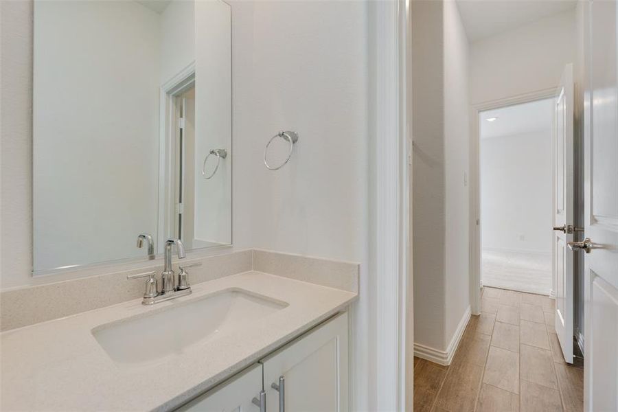 Bathroom with vanity and wood-type flooring