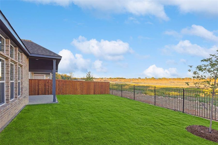 View of yard with a rural view