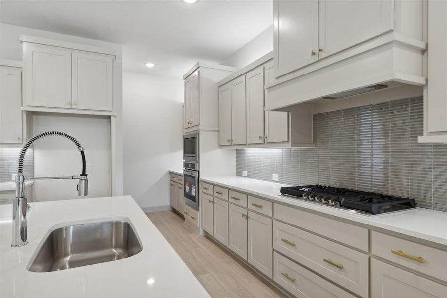 This beautiful kitchen offers shaker style cabinetry & quartz paired with all of the modern conveniences you are looking for in a dream kitchen.