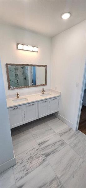 Bathroom with vanity and a shower with shower door