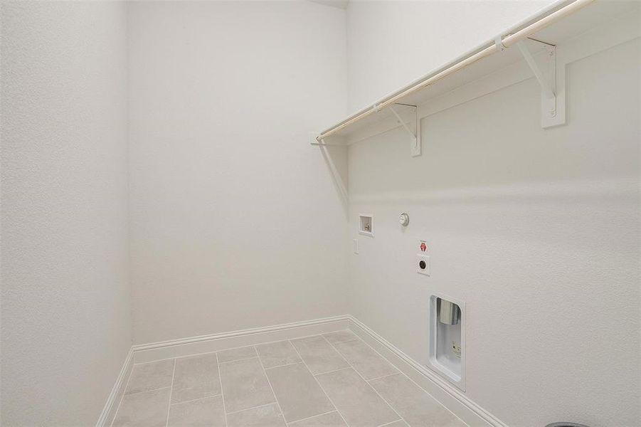 Laundry room with hookup for a gas dryer, tile patterned floors, hookup for an electric dryer, and washer hookup