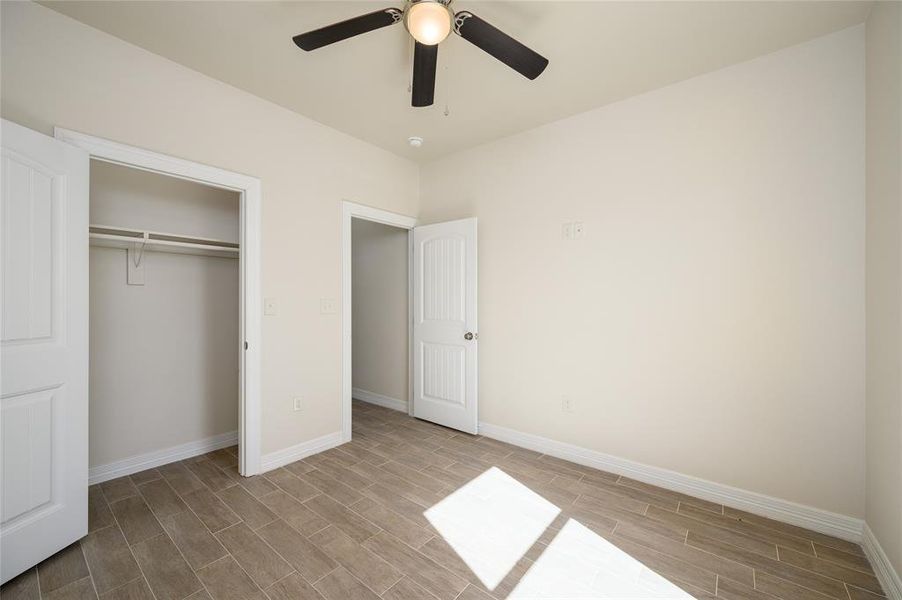 Unfurnished bedroom with light hardwood / wood-style floors, a closet, and ceiling fan