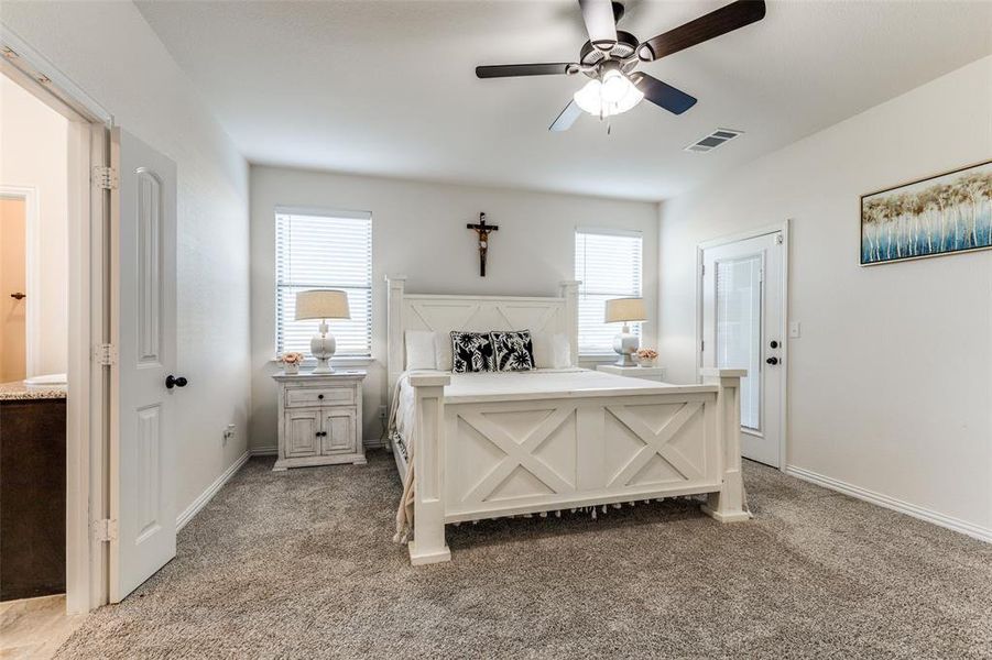 Bedroom featuring light carpet and ceiling fan