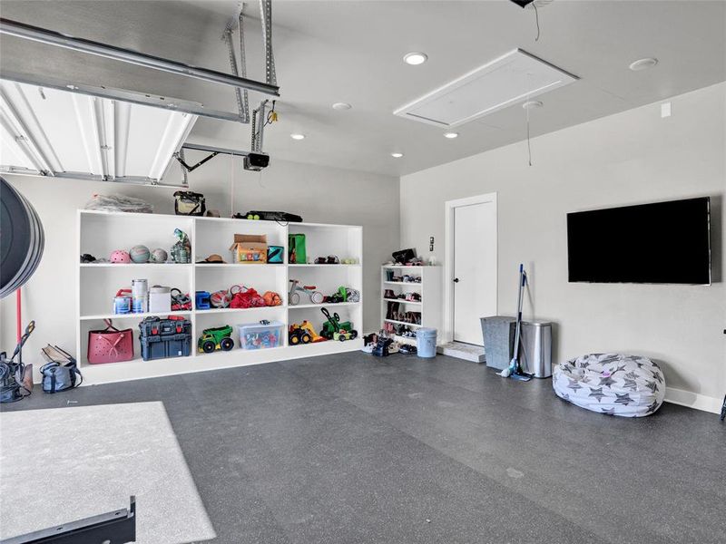 Garage featuring almost 10K in professional gym flooring and built-ins.