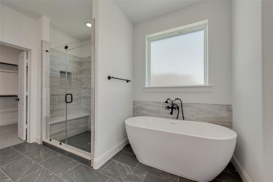Bathroom with tile patterned flooring and independent shower and bath