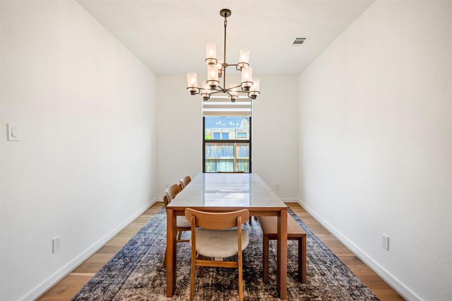 Make memories gathered around the table with your family and friends! This dining room features high ceilings, wood flooring, bright natural light, and a beautiful chandelier!