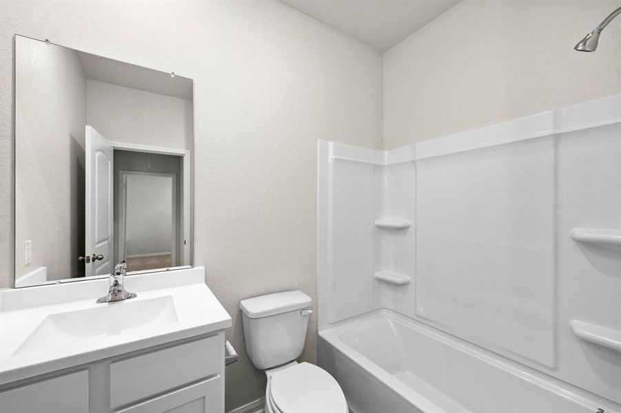 The secondary bathroom, located centrally in the hallway of the home.