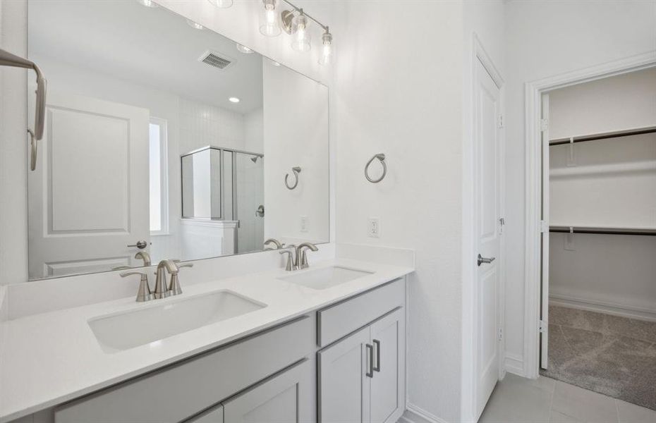 Spacious owner's bathroom with dual vanity *real home pictured