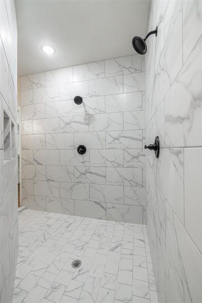 Bathroom featuring a tile shower