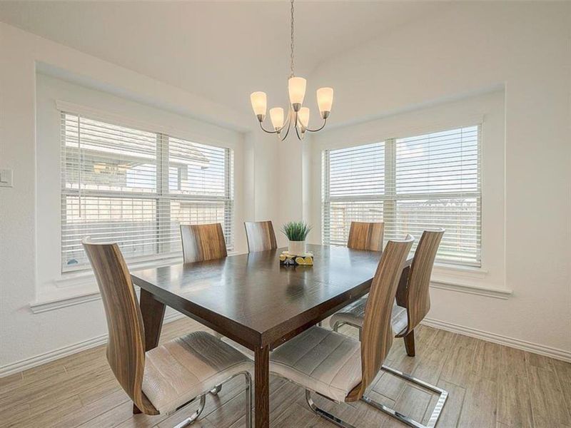 This formal dining room is perfect for hosting dinner parties. The large table can seat eight comfortably, and the chandelier adds a touch of glamour.