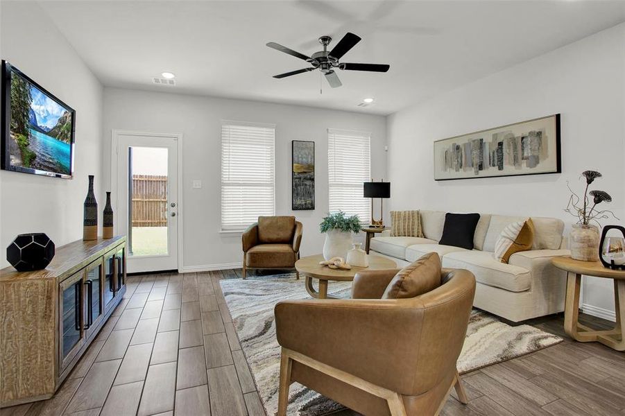 Living room with hardwood / wood-style flooring and ceiling fan