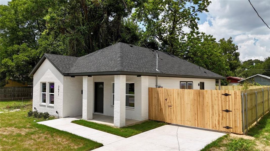 View of front of house with a patio and a front yard