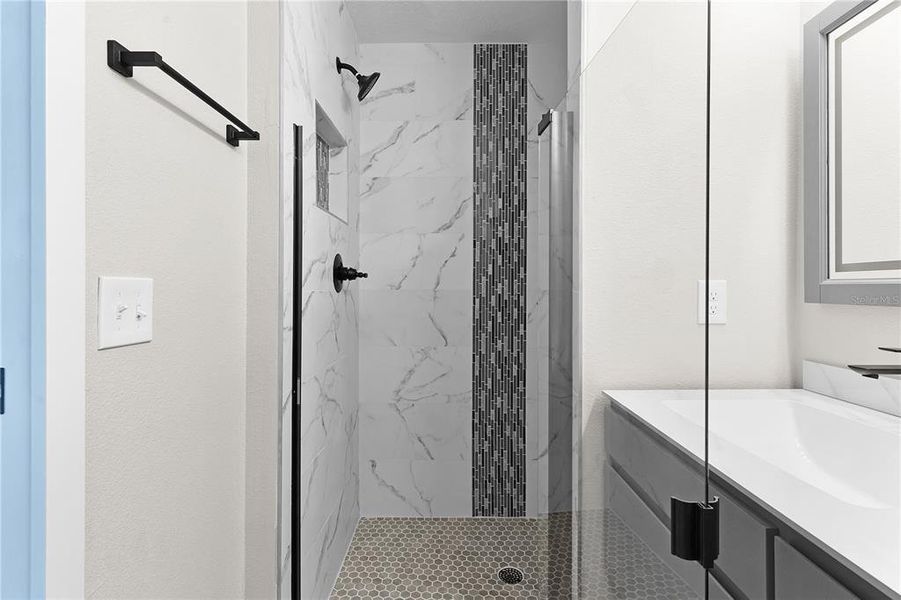 Primary bathroom with custom tiled shower