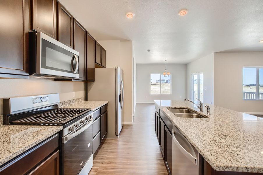 Kitchen and breakfast nook of the ranch style Telluride plan by Century Communities