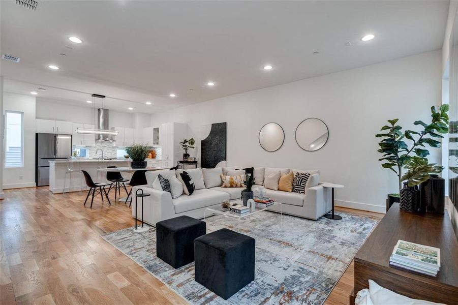 Living room with light wood-type flooring and sink