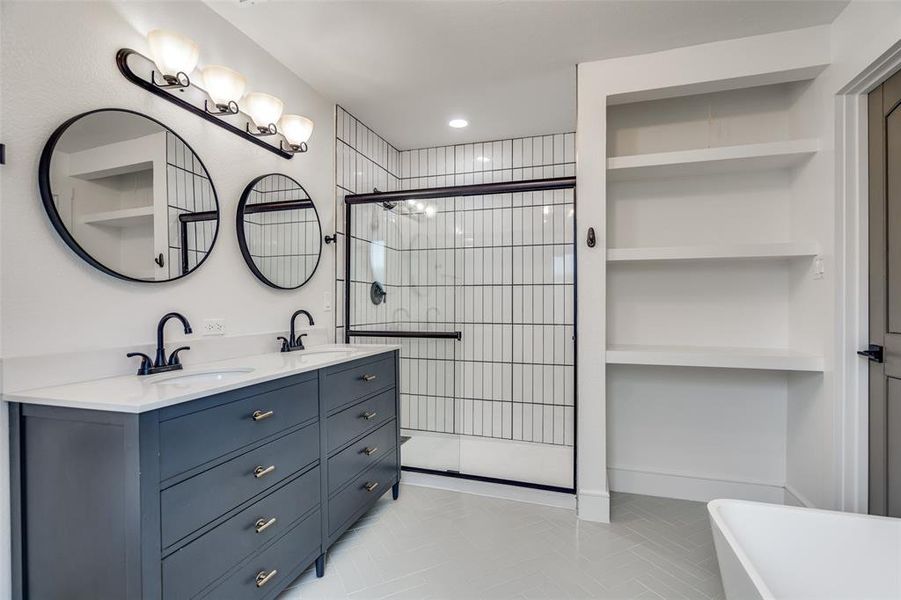Primary bathroom offers stunning upscale enhancements like chic choices in lighting and furniture design.