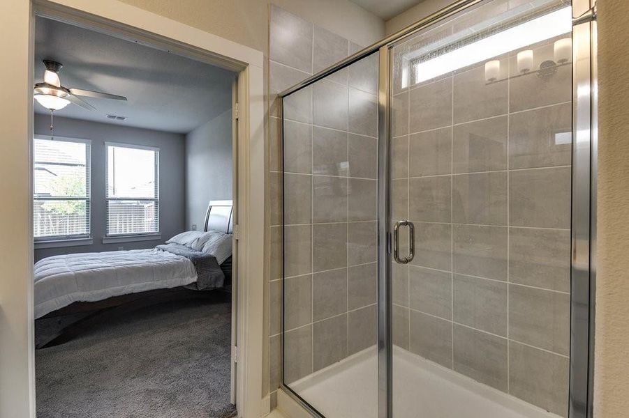 Walk-in shower with decorative tile for the owner's suite.