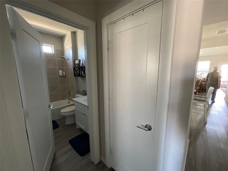 Full bathroom with a healthy amount of sunlight, vanity, toilet, and tiled shower / bath combo